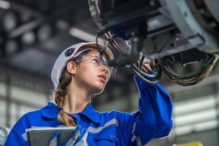services-electric-motor-service-on-site Woman in protective clothing inspects an industrial plant