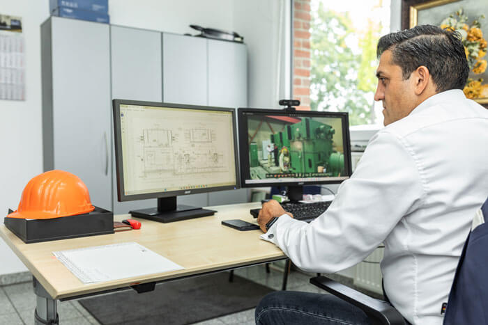 Employee from the Engineering department sits at the computer