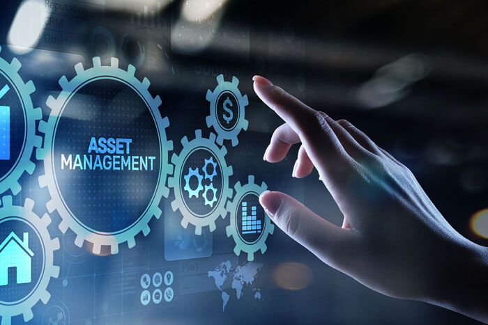 innovation-total-asset-management-rundum-service Eine Hand zeigt auf eine holografische Darstellung von Zahnrädern mit dem Begriff Asset Management